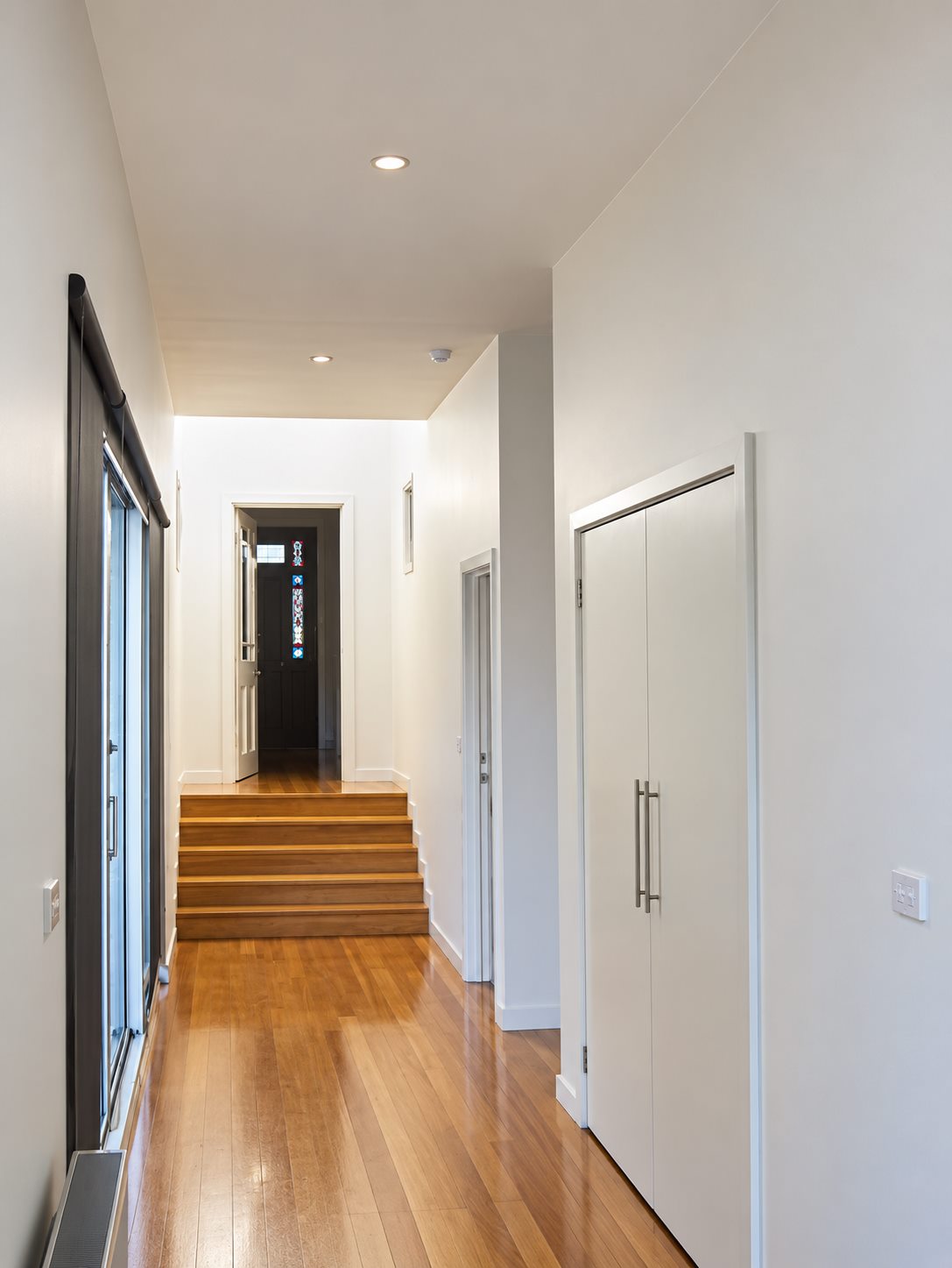 The hall in the new work, looking back up the steps to the original stained glass front door