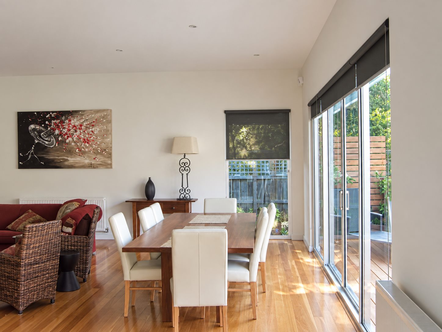 Living and dining at the rear, sliding doors out to the deck and the battened screens