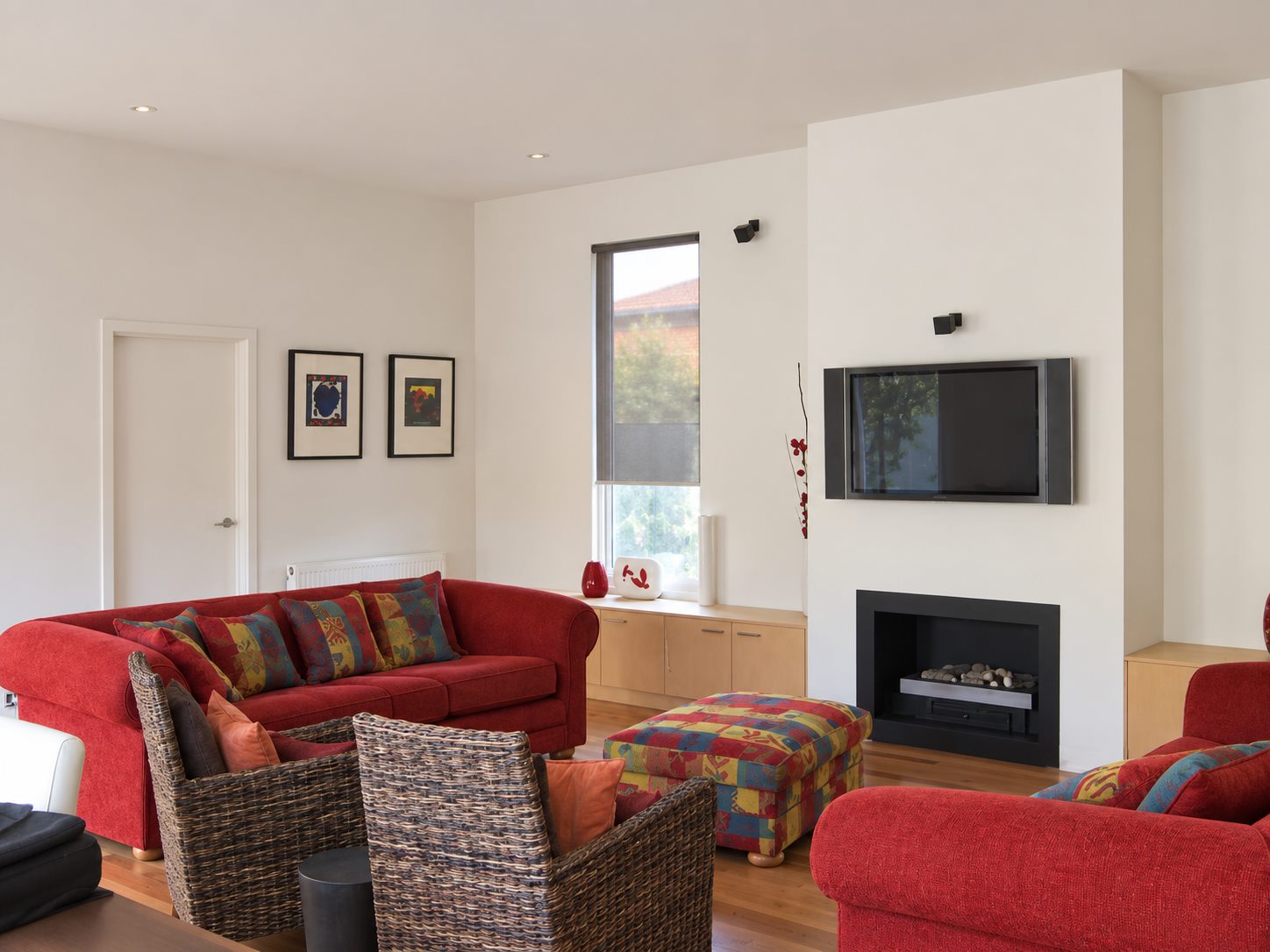 The sitting room with its fireplace set into a plain rendered chimney breast