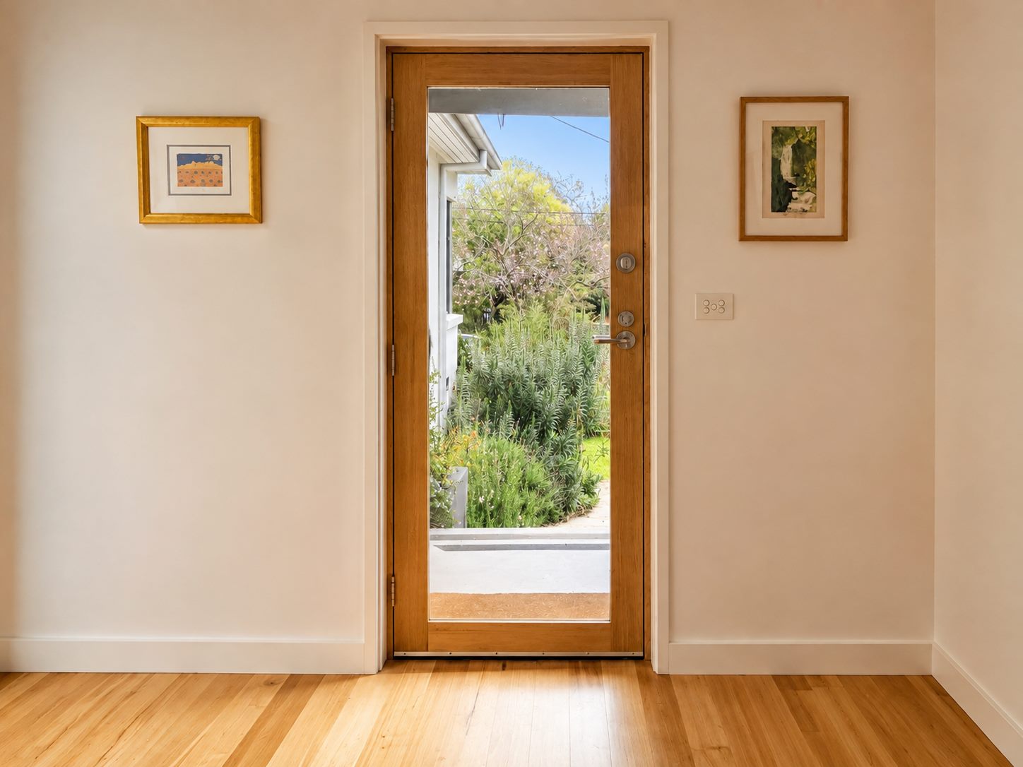 Glazed timber front door and hardwood floor at the entry