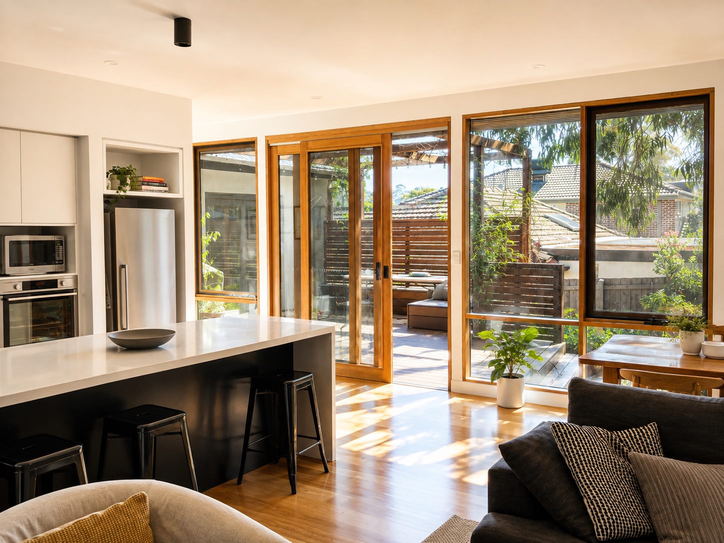 Kitchen and living room, sliding doors open onto the deck
